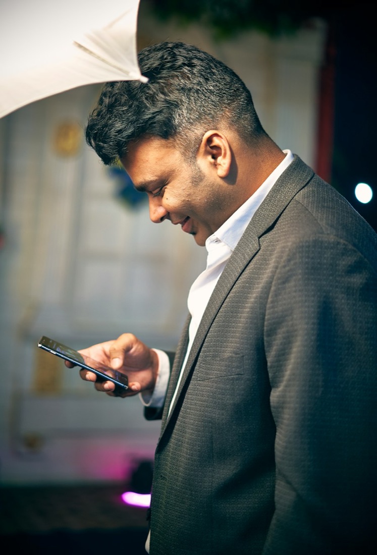 Property professional checking his leads on his phone